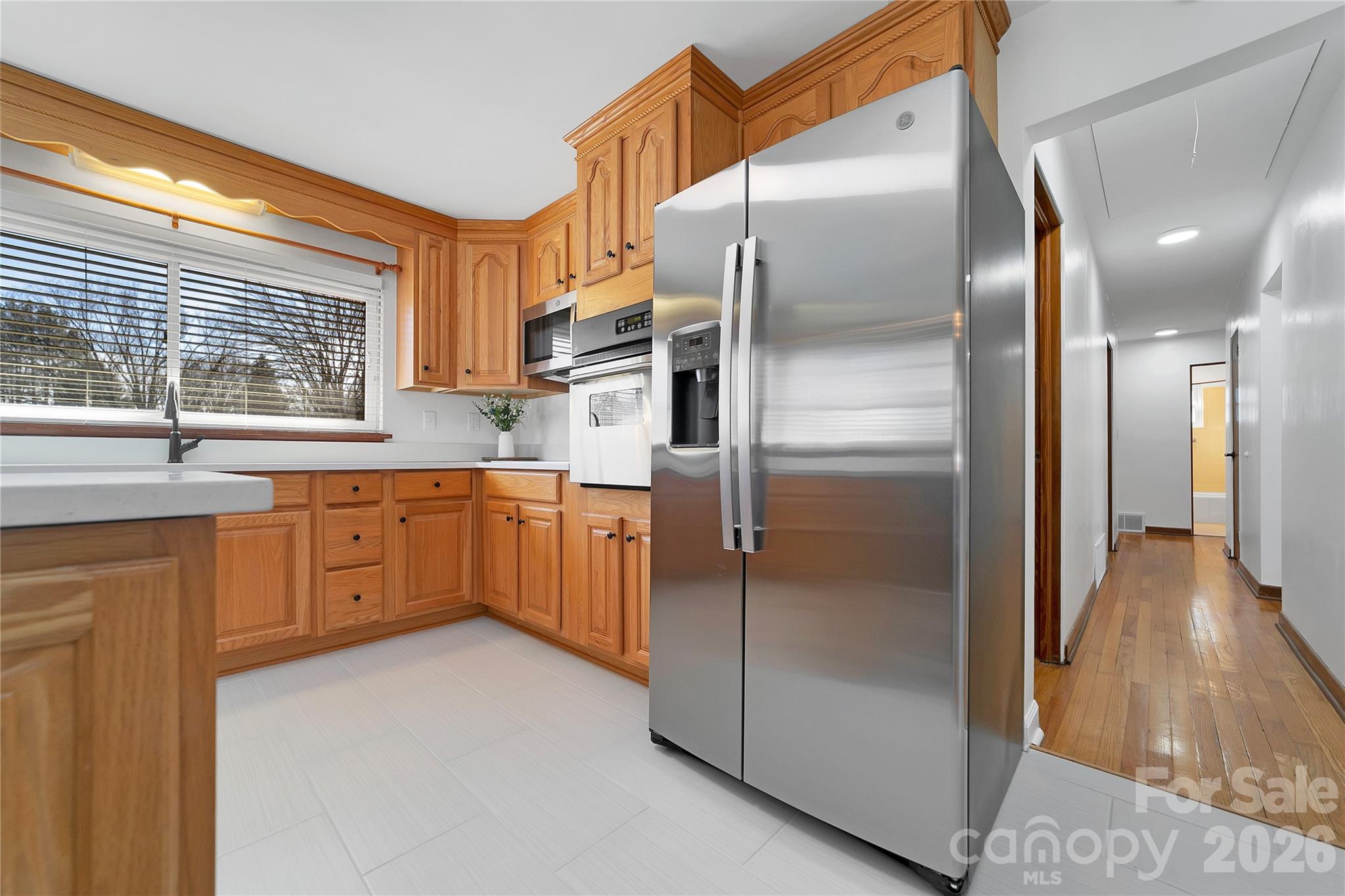 112 Allison Road Brevard, NC 28712 - Photo 15 of 37 a kitchen with stainless steel appliances a refrigerator sink and cabinets