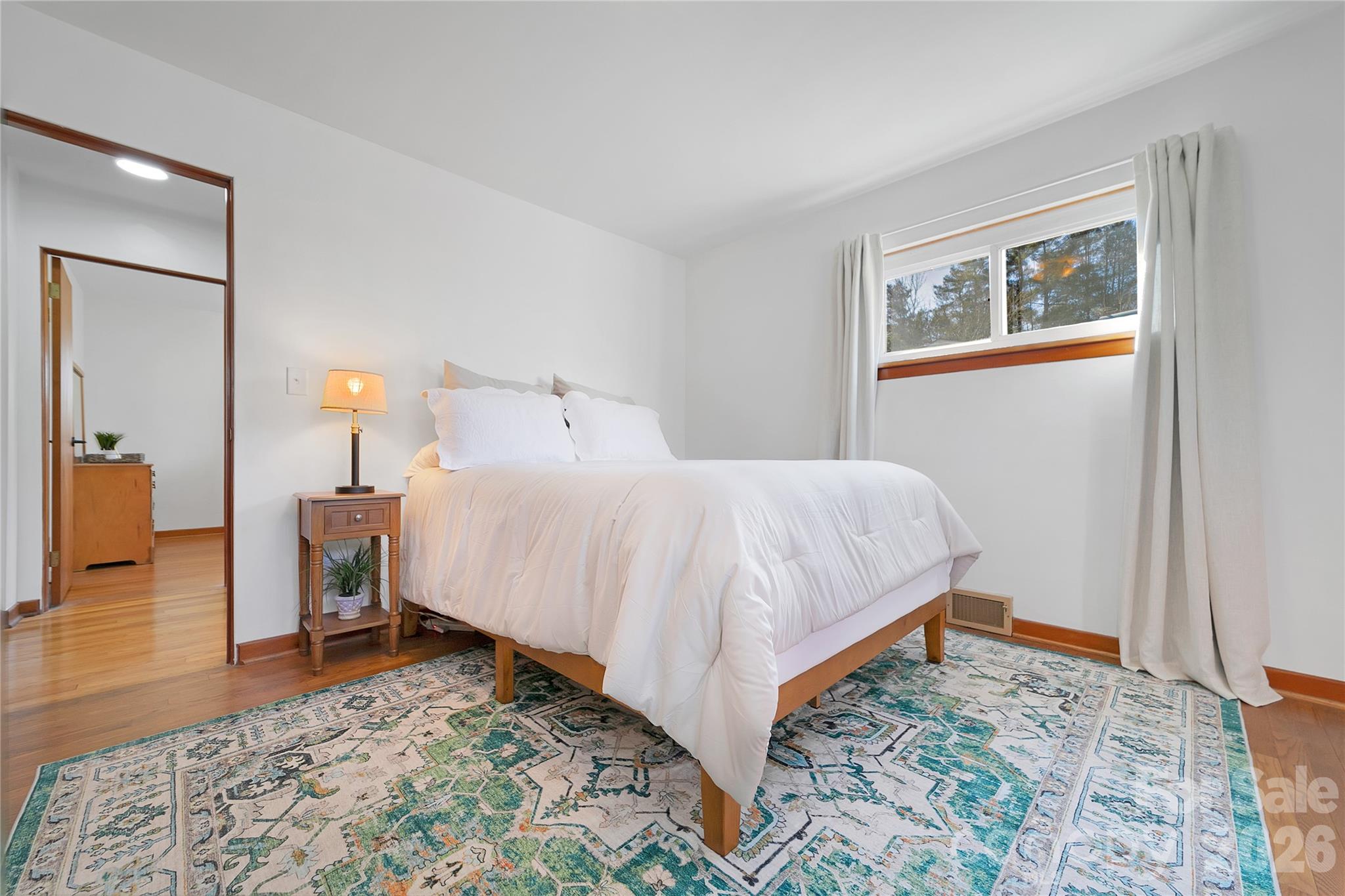 112 Allison Road Brevard, NC 28712 - Photo 16 of 37 a bedroom with a bed and wooden floor
