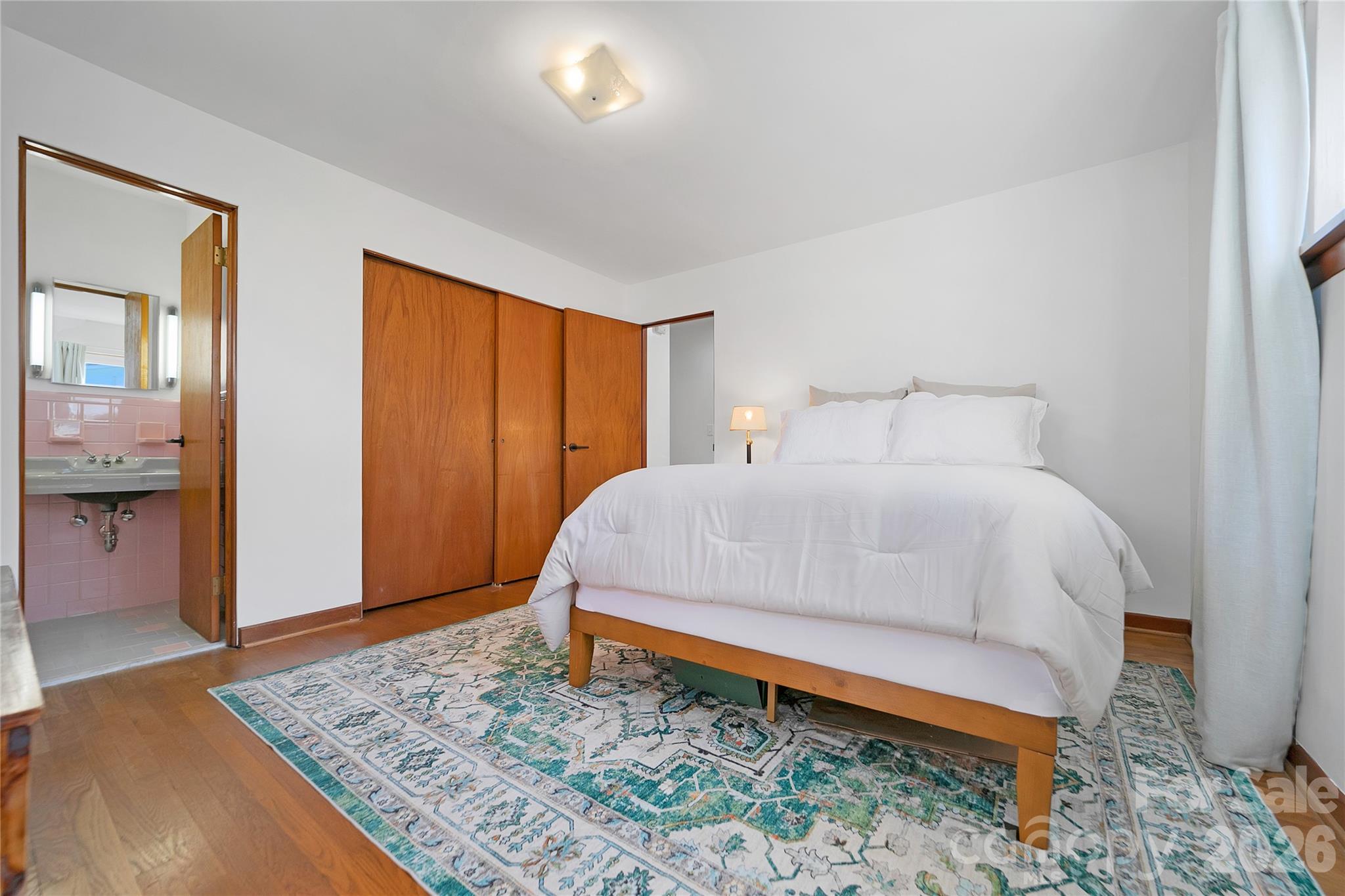 112 Allison Road Brevard, NC 28712 - Photo 18 of 37 a bed sitting in a spacious bedroom next to a window