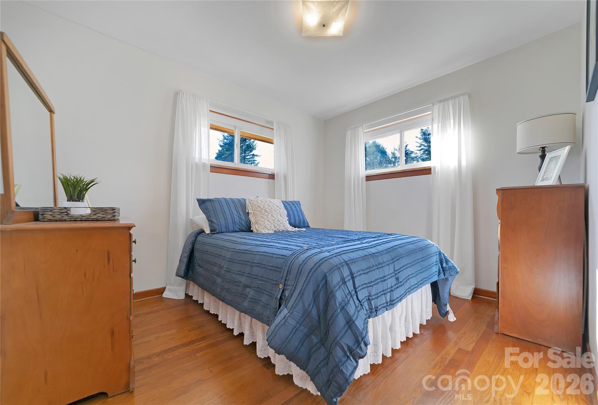 112 Allison Road Brevard, NC 28712 - Photo 20 of 37 a bedroom with a bed and a painting on the wall