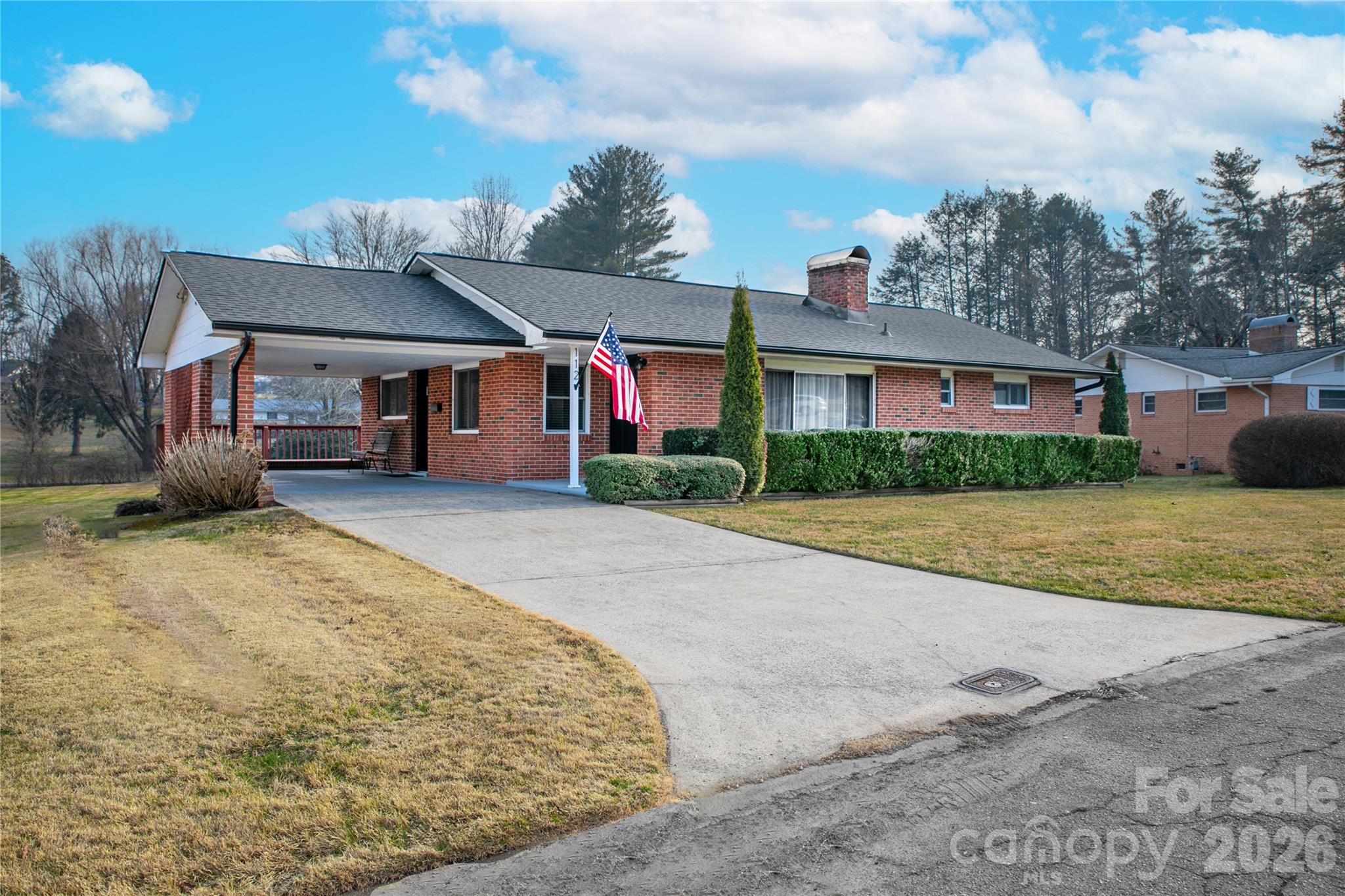 112 Allison Road Brevard, NC 28712 - Photo 5 of 37 a front view of a house with a yard and garage