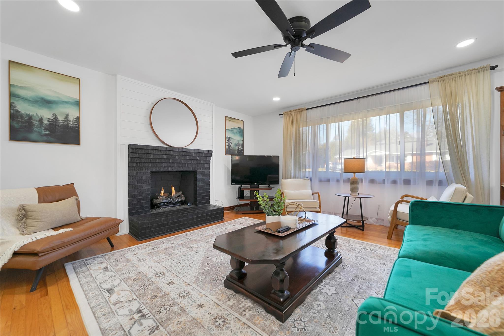 112 Allison Road Brevard, NC 28712 - Photo 6 of 37 a living room with furniture and a fireplace
