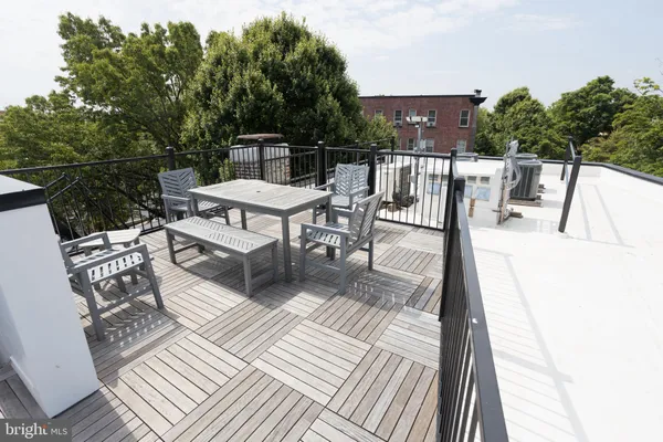 a view of a patio with a table and chairs
