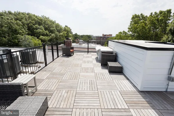 a view of balcony with wooden floor and outdoor seating