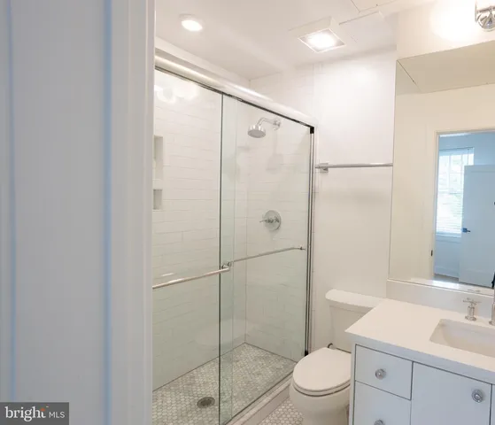 a bathroom with a shower a toilet and sink