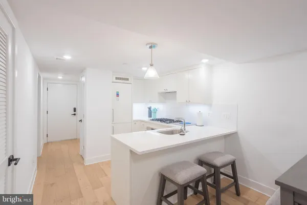 a kitchen with a sink stainless steel appliances and cabinets