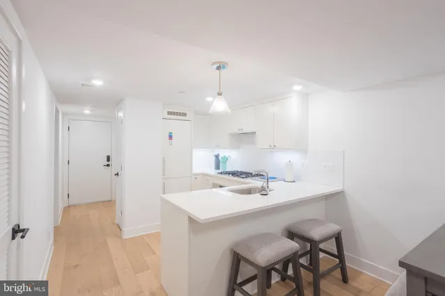 a kitchen with a sink stainless steel appliances and cabinets