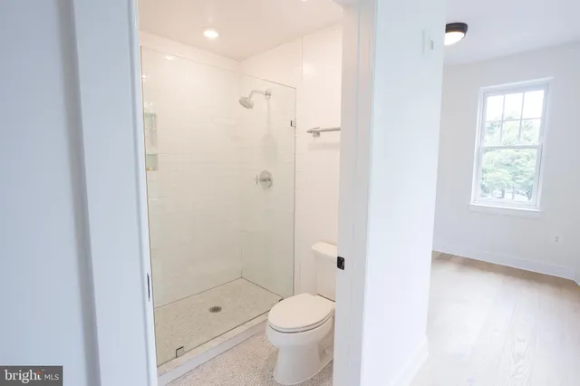 a bathroom with a shower toilet and sink