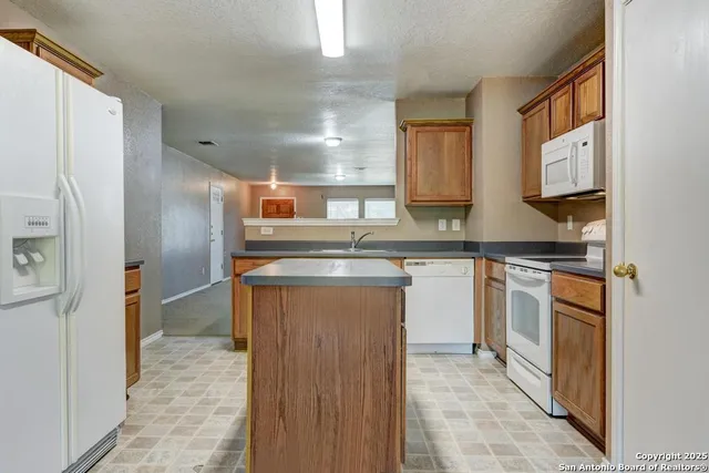a kitchen with a sink stove and refrigerator