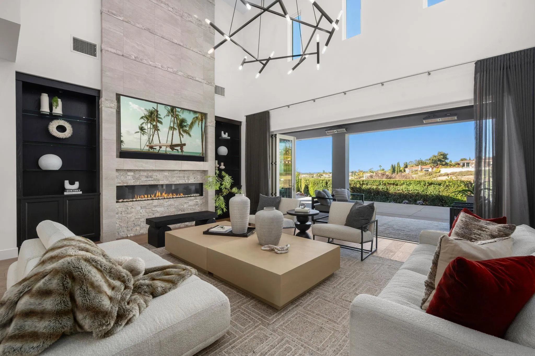 6968 St Andrews Road Rancho Santa Fe, CA 92067 - Photo 4 of 23 a living room with furniture a floor to ceiling window and a flat screen tv
