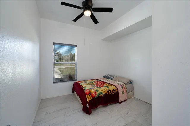 a bed sitting in a bedroom next to a window