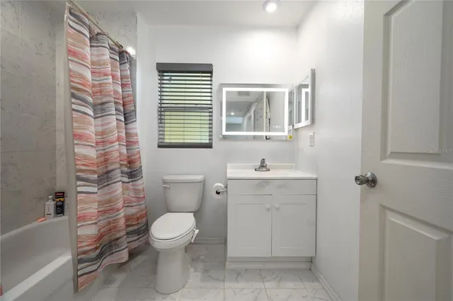 a bathroom with a toilet a sink and a bathtub