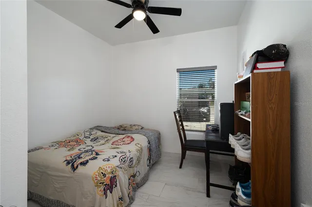 a bedroom with a bed and a window