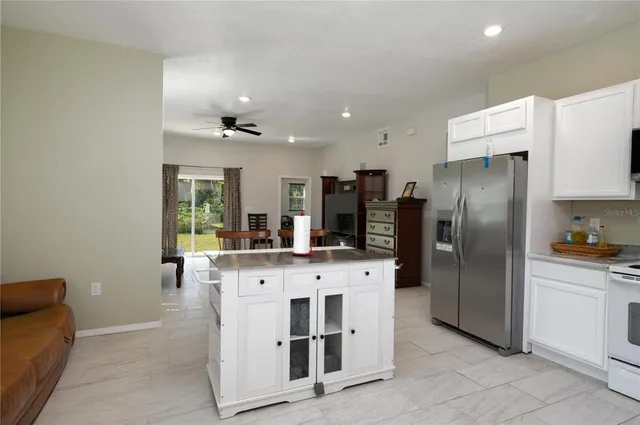 a kitchen with stainless steel appliances a refrigerator sink and stove
