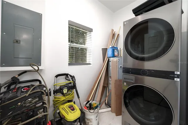 a view of a bedroom with washer and dryer