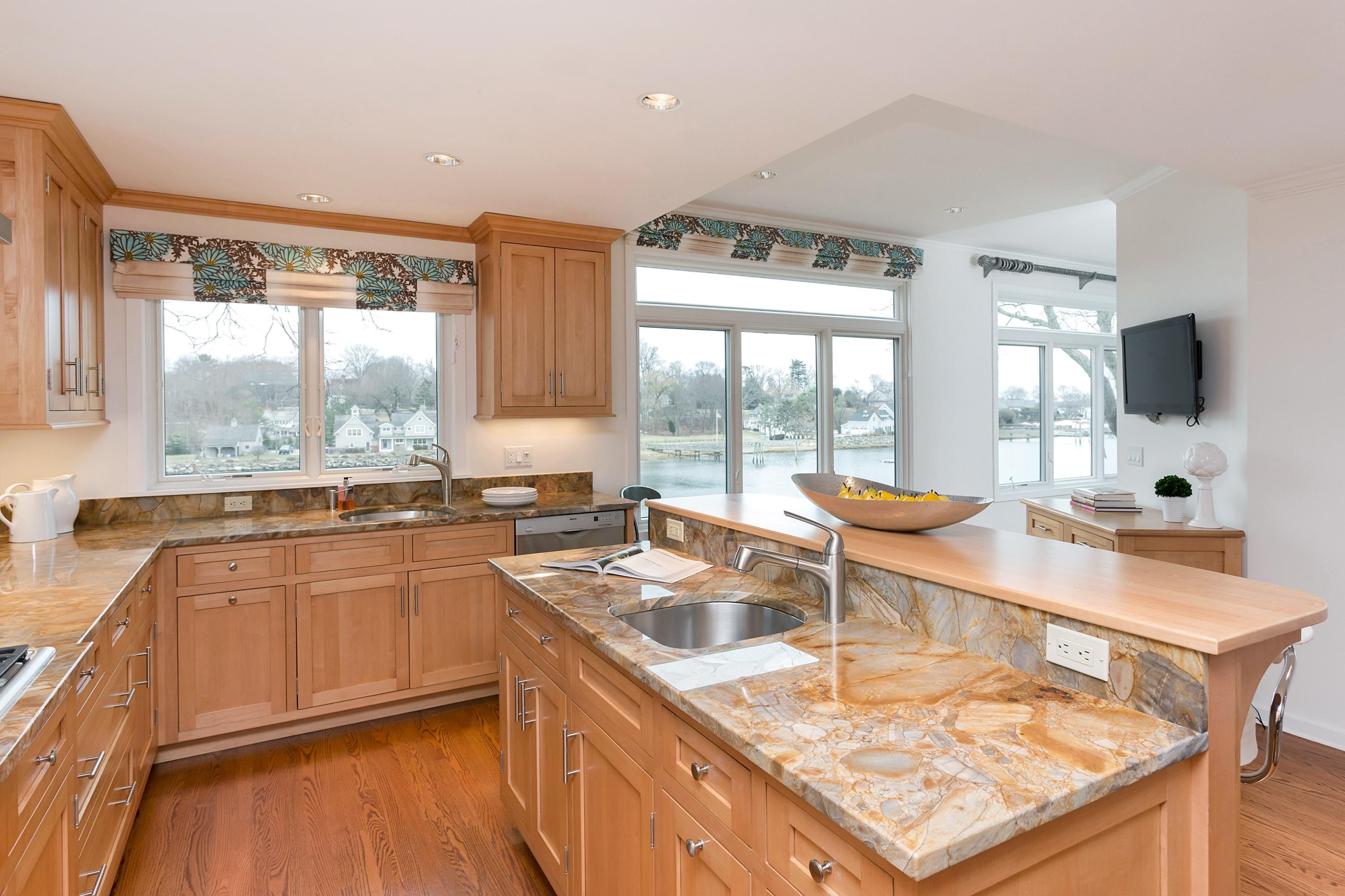 17 Thomas Place Rowayton, CT 06853 - Photo 13 of 37 a kitchen with stainless steel appliances granite countertop sink stove and wooden floor