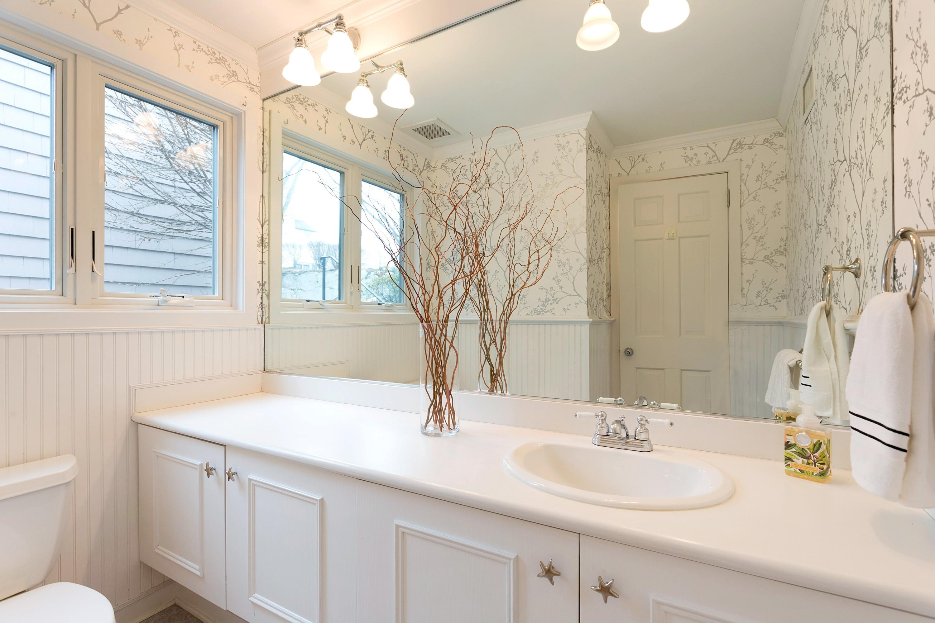 17 Thomas Place Rowayton, CT 06853 - Photo 16 of 37 a bathroom with a sink vanity granite toilet and a mirror