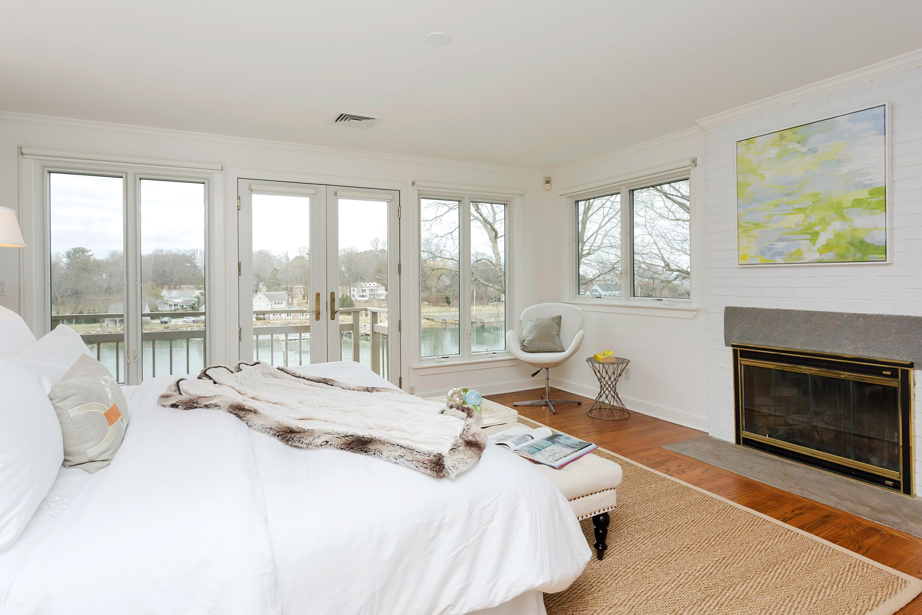 17 Thomas Place Rowayton, CT 06853 - Photo 18 of 37 a spacious bedroom with a bed and a fireplace