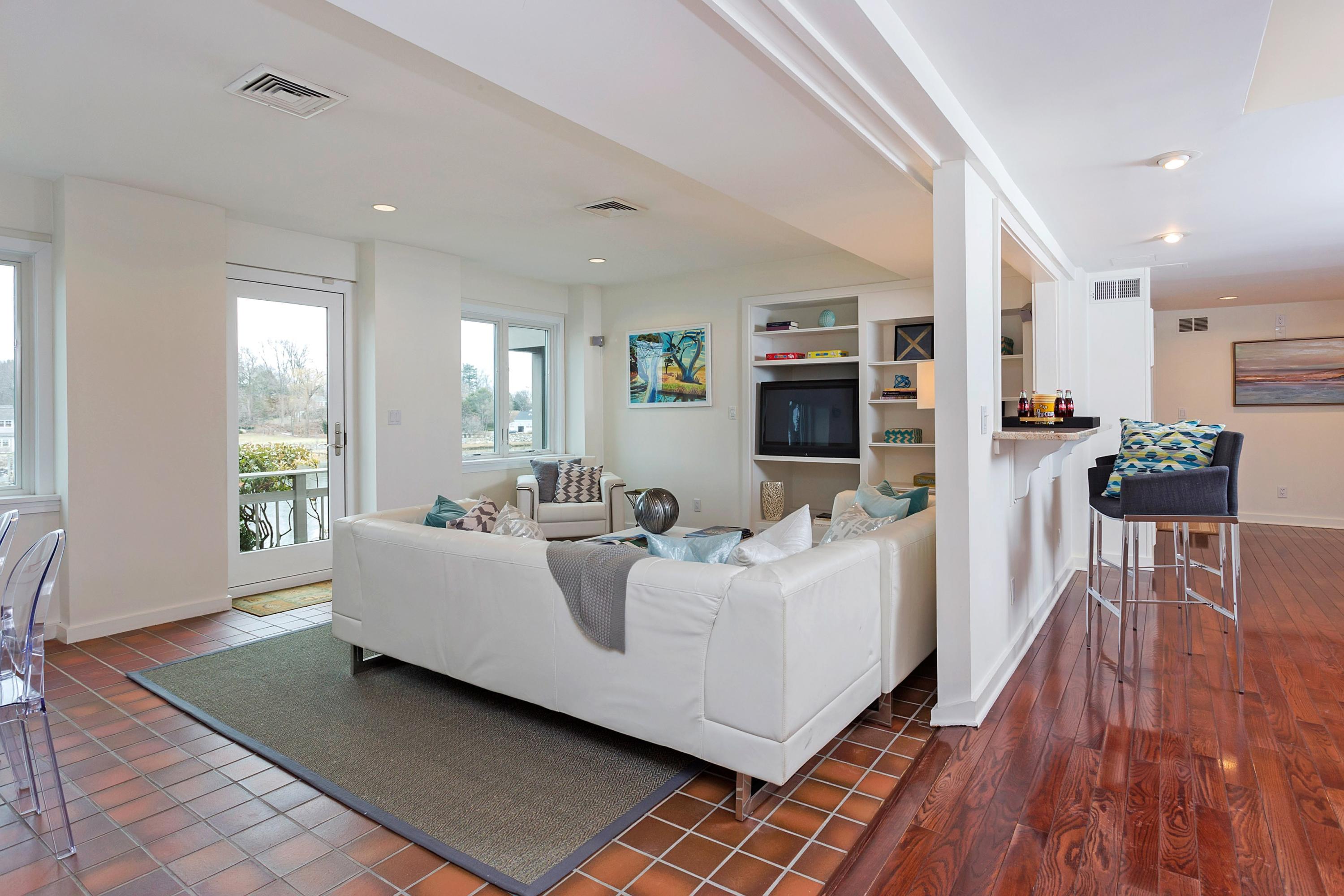 17 Thomas Place Rowayton, CT 06853 - Photo 24 of 37 a living room with furniture a flat screen tv and a wooden floor