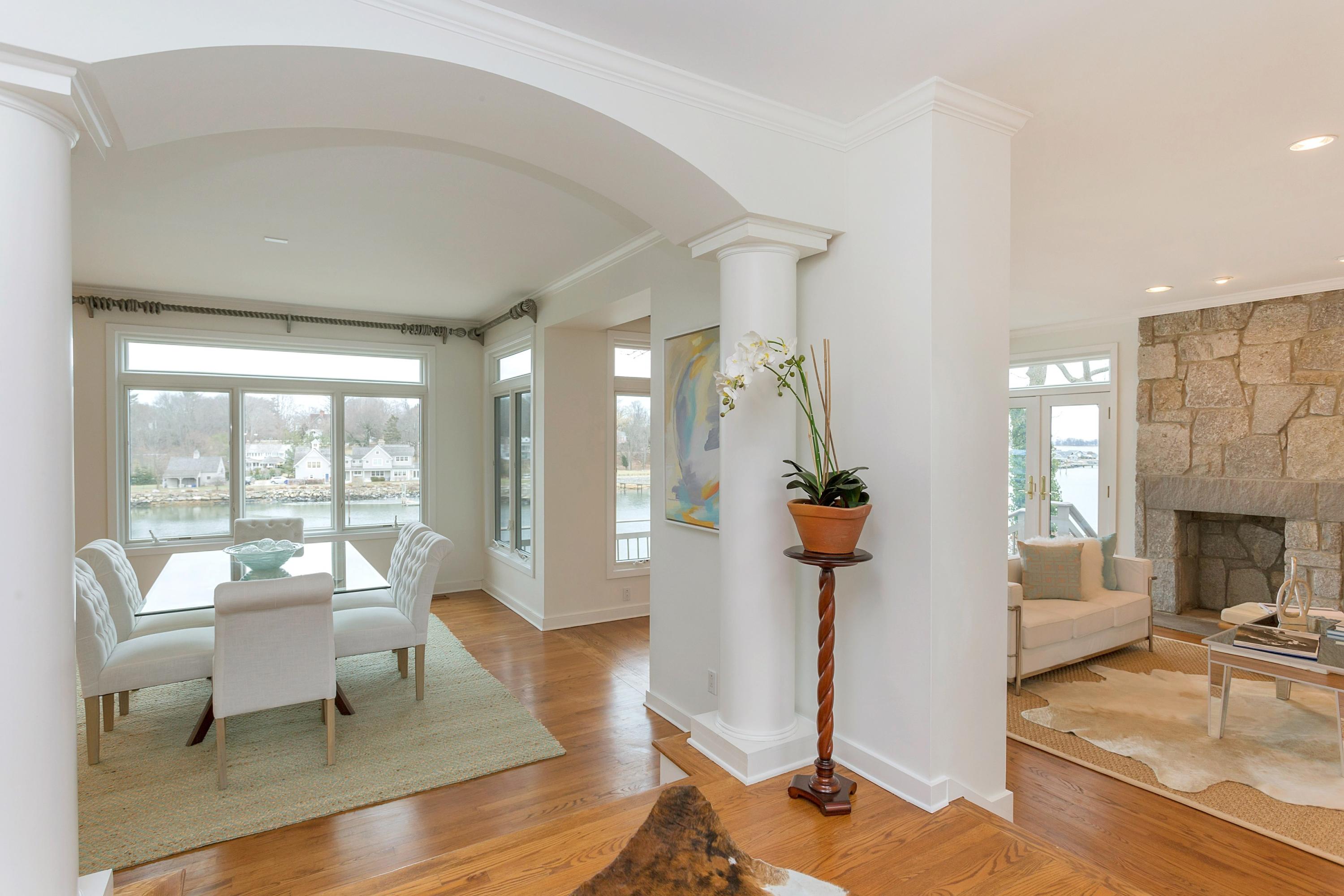 17 Thomas Place Rowayton, CT 06853 - Photo 6 of 37 a living room with furniture a fireplace and potted plants with wooden floor