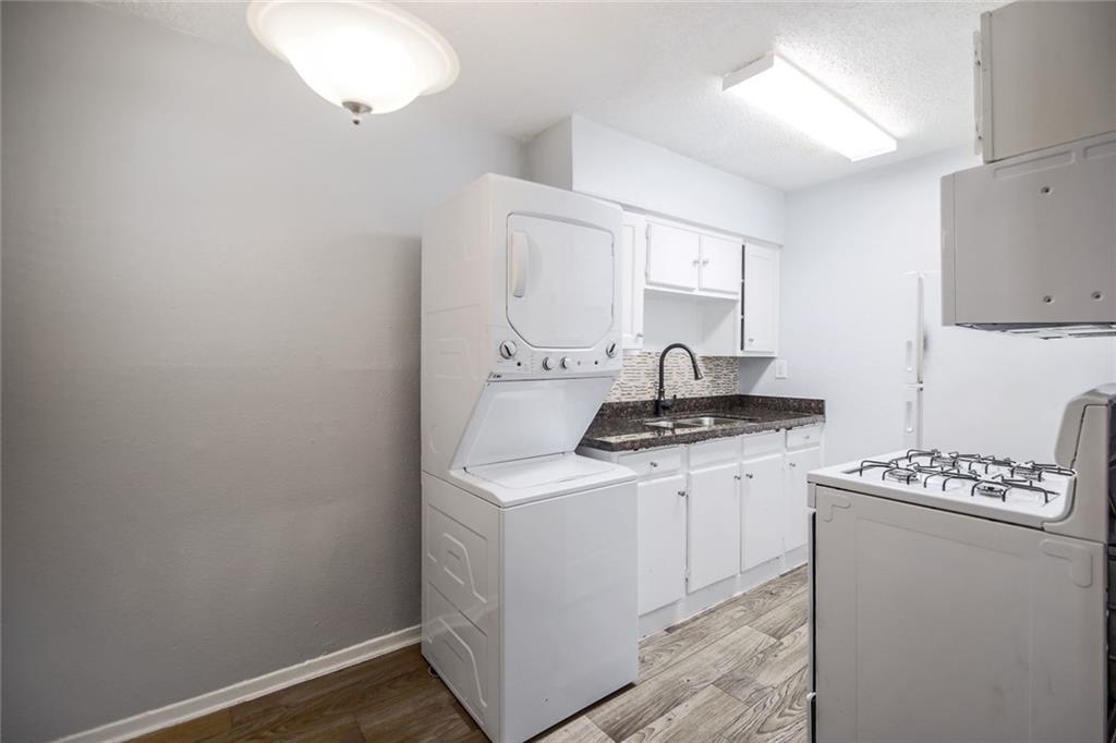 2401 Manor Road, Unit 221 Austin, TX 78722 - Photo 10 of 21 A well-appointed kitchen featuring a convenient stacked washer/dryer and efficient appliances.