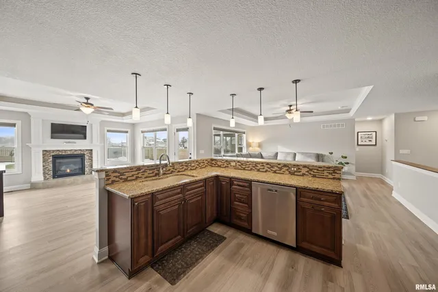 a kitchen with stainless steel appliances granite countertop a stove and a sink