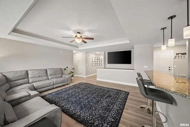 a spacious bedroom with a bed and a chandelier