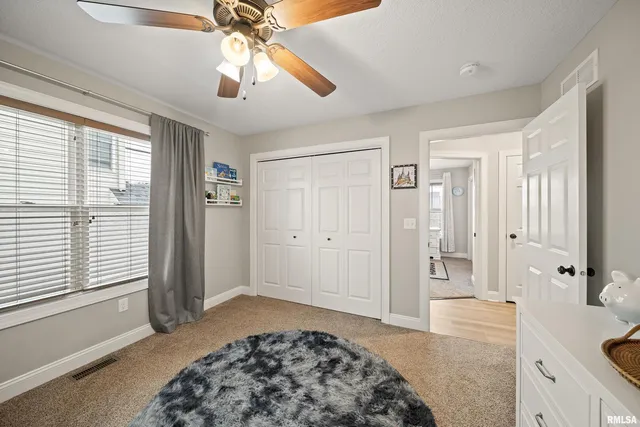 a bathroom with a granite countertop sink a toilet and a mirror