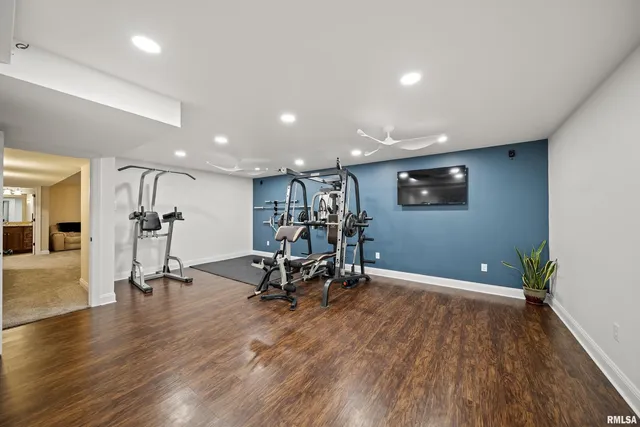 a bathroom with a granite countertop sink mirror vanity and toilet