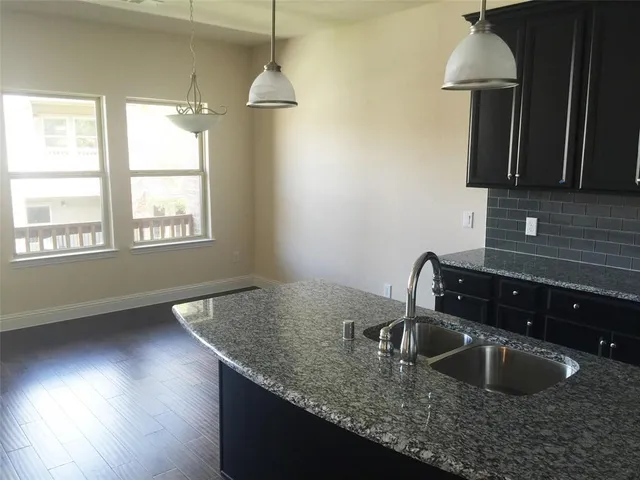 a kitchen with sink and window
