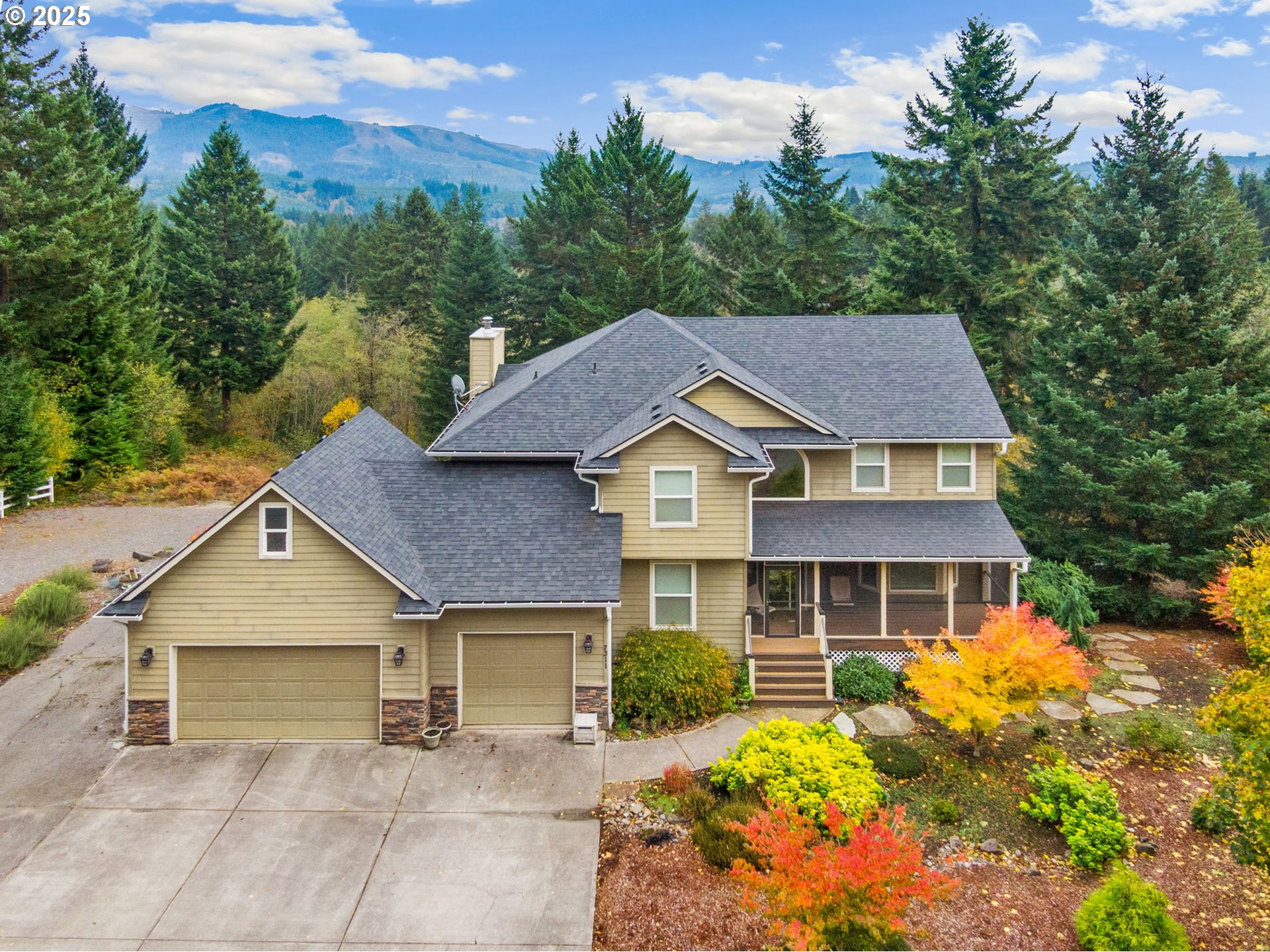 a aerial view of a house with a yard and potted plants