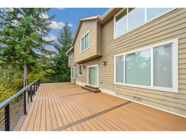 a view of backyard with a deck and wooden floor