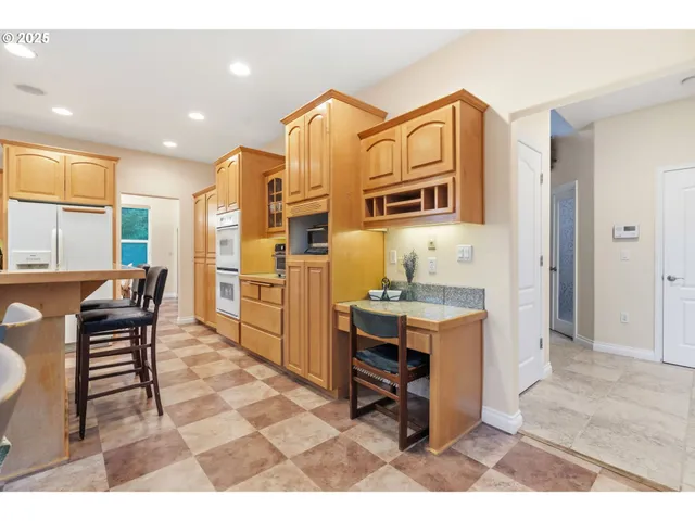 a living room with stainless steel appliances kitchen island granite countertop furniture and a kitchen view