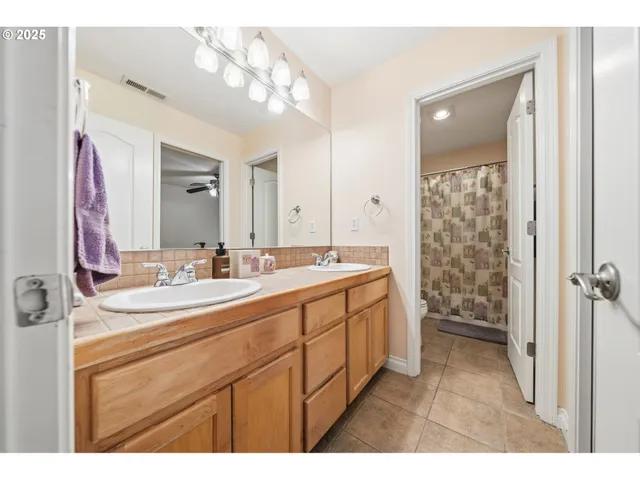 a bathroom with a sink a mirror and a shower