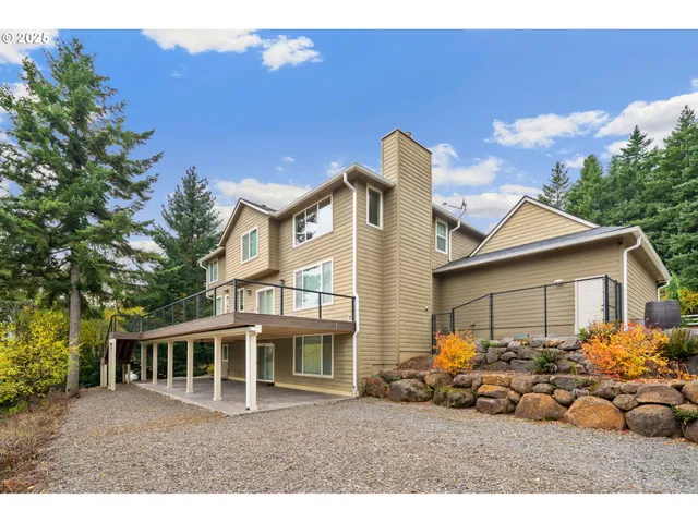 a view of a house with a big yard and potted plants