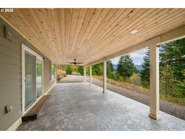 a view of a patio with table and chairs