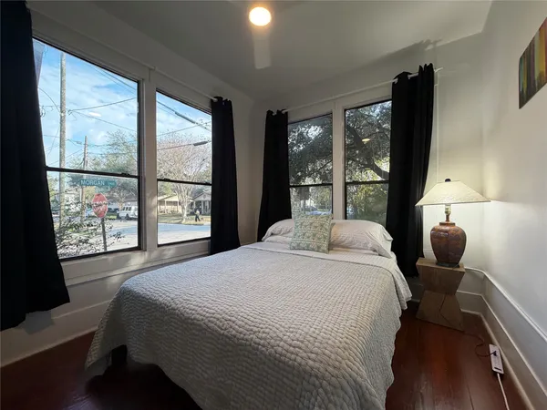 a bedroom with a large bed and a large window