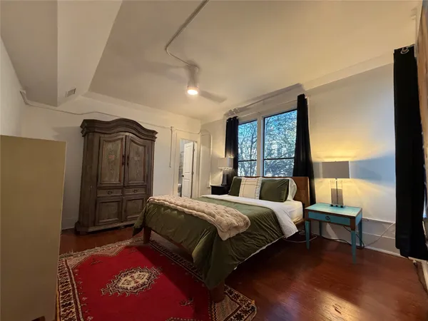 a bedroom with a bed and a window