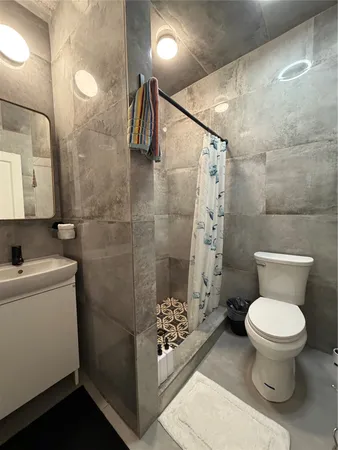 a bathroom with a toilet sink and shower