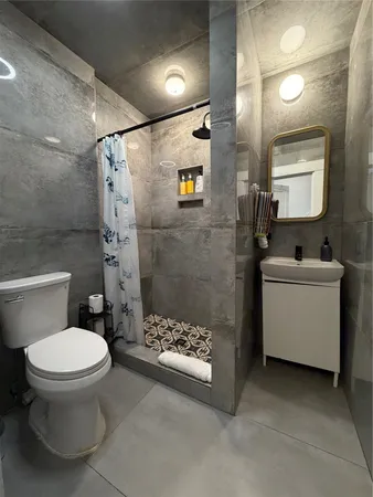a bathroom with a sink toilet and shower