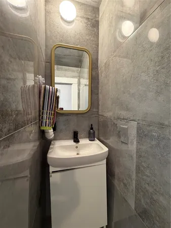 a bathroom with a sink toilet and mirror