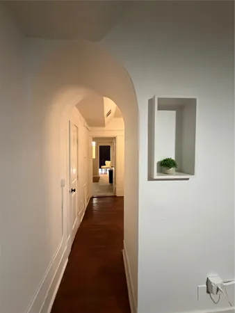 a view of a hallway with a dining room