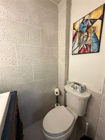 a white toilet sitting next to a bathroom sink
