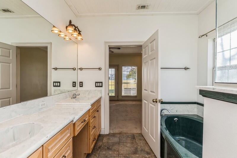 1510 Vinson Ray Road Baker, FL 32531 - Photo 32 of 60 a spacious bathroom with a granite countertop sink a mirror and a shower
