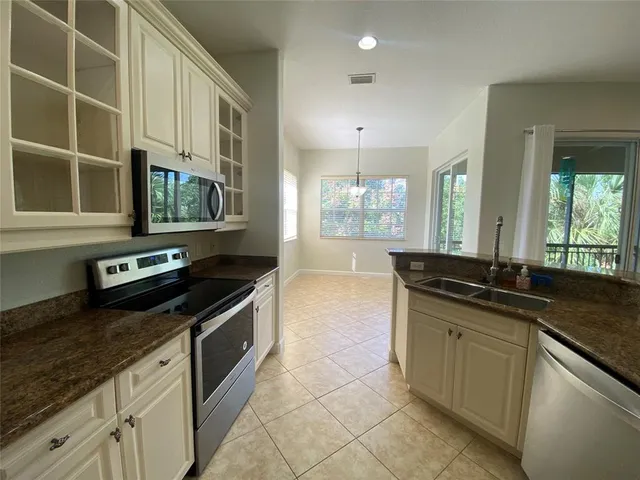 a kitchen with a sink stainless steel appliances and cabinets