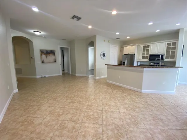 a kitchen with stainless steel appliances granite countertop a refrigerator a stove a sink and a refrigerator