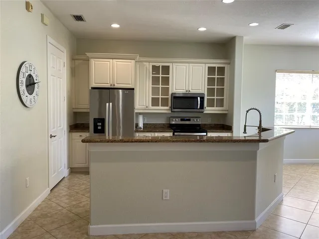 a kitchen with stainless steel appliances granite countertop a stove and a sink