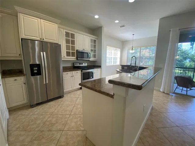 a kitchen with a sink window and cabinets