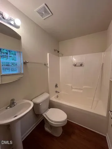 a bathroom with a toilet a sink and bathtub