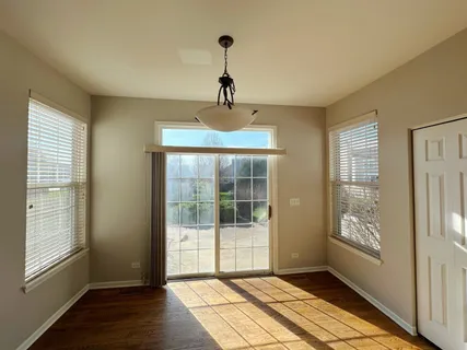 a view of an empty room with glass door